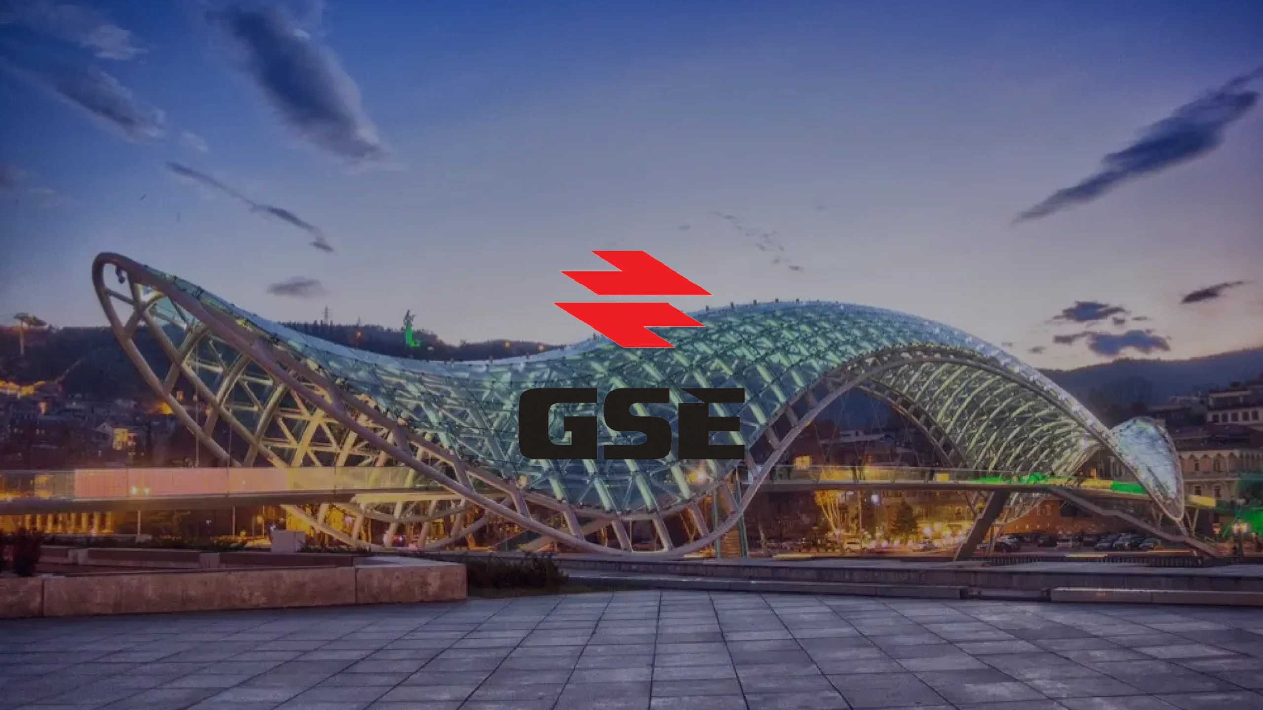 https://ips-energy.com/de/wp-content/uploads/sites/3/2025/09/modern-glass-pedestrian-bridge-wave-dusk-red-logo.webp