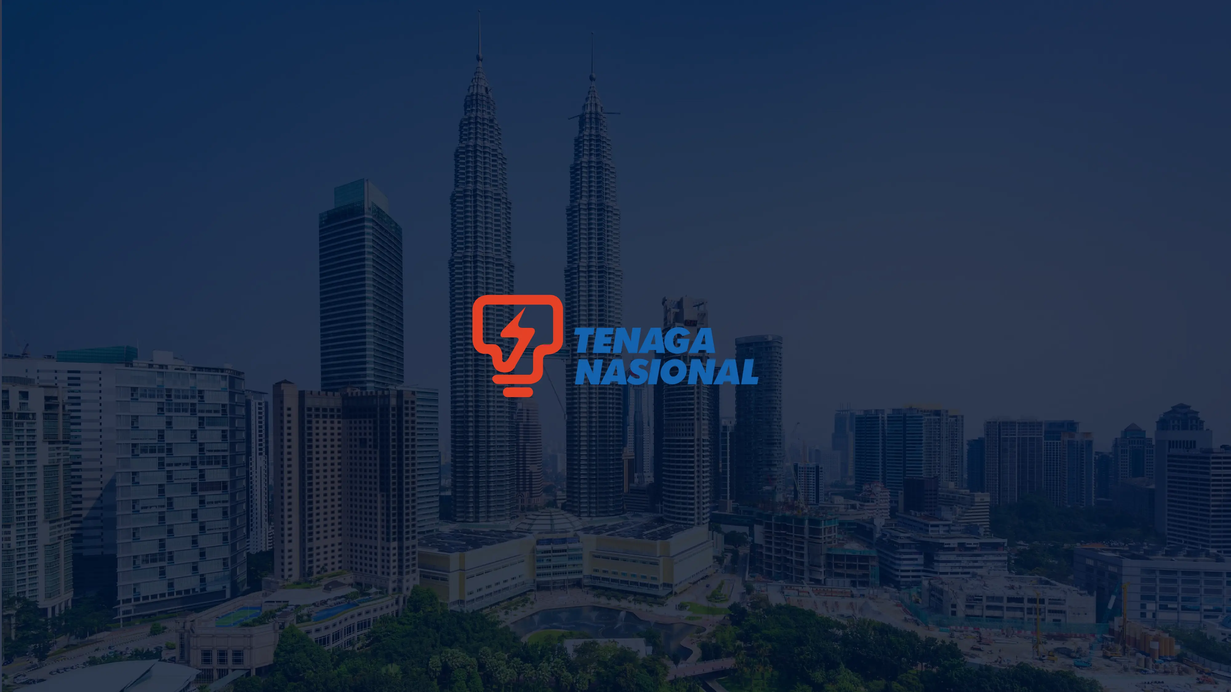 Kuala Lumpur skyline with Petronas Twin Towers and Tenaga Nasional logo overlay.